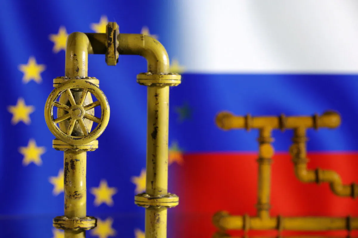 Model of natural gas pipeline with EU and Russia flags on the background, on July 18, 2022. (Dado Ruvic/Reuters)