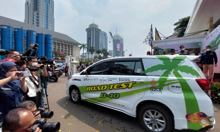 People take pictures of a car road test for fuel with 40 percent palm based biodiesel blending at a Ministry of Energy and Mineral Resources area in Jakarta, Indonesia on July 27, 2022. (Bernadette Christina Munthe/Reuters)