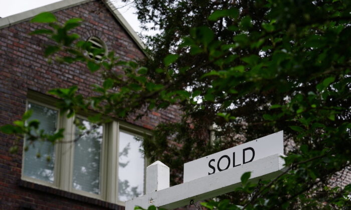 A "sold" sign outside of a recently purchased home in Washington on July 7, 2022. (Sarah Silbiger/Reuters)