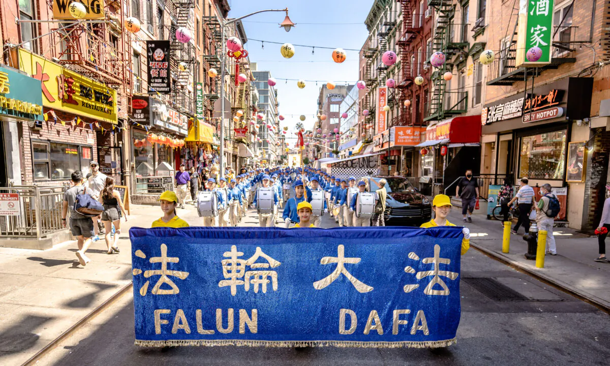 Falun Gong practitioners take part in a parade to commemorate the 23rd anniversary of the persecution of the spiritual discipline in China, in New York's Chinatown on July 10, 2022. (Samira Bouaou/The Epoch Times)