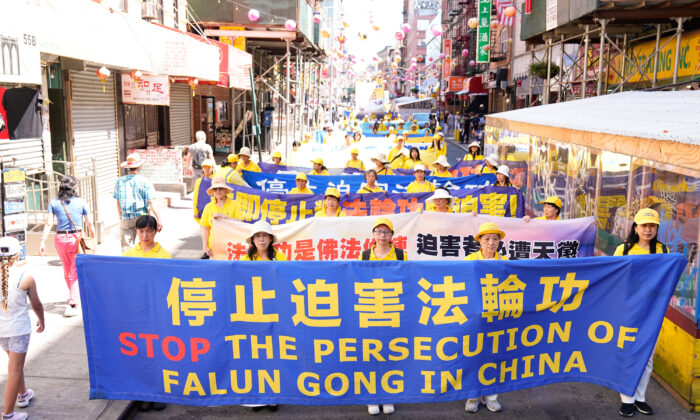 Falun Gong practitioners take part in a parade to commemorate the 23rd anniversary of the persecution of the spiritual discipline in China, in New York's Chinatown on July 10, 2022. (Larry Dye/The Epoch Times)