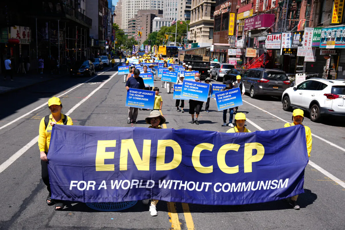 Falun Gong practitioners take part in a parade to commemorate the 23rd anniversary of the persecution of the spiritual discipline in China, in New York's Chinatown on July 10, 2022. (Larry Dye/The Epoch Times)
