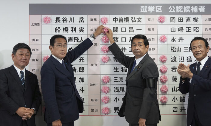 Fumio Kishida (2nd L), Japan's prime minister and president of the Liberal Democratic Party (LDP), speaks after placing a red paper rose on an LDP candidate's name, to indicate a victory in the upper house election, at the party's headquarters in Tokyo, on July 10, 2022. (Toru Hanai/Pool Photo via AP)