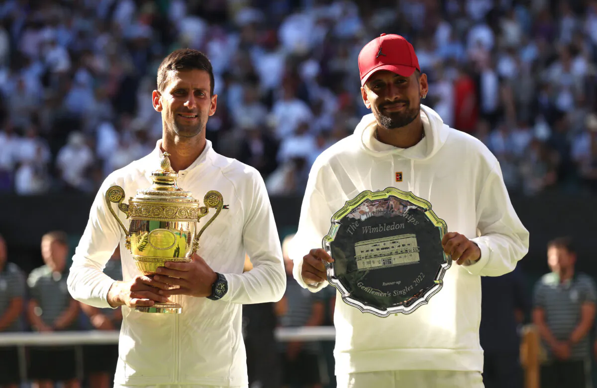 Winner Novak Djokovic of Serbia (L) and runner up Nick Kyrgios of Australia pose for a photo with their trophies following their Men's Singles Final match on day 14 of The Championships Wimbledon 2022 at All England Lawn Tennis and Croquet Club in London on July 10, 2022. (Julian Finney/Getty Images)