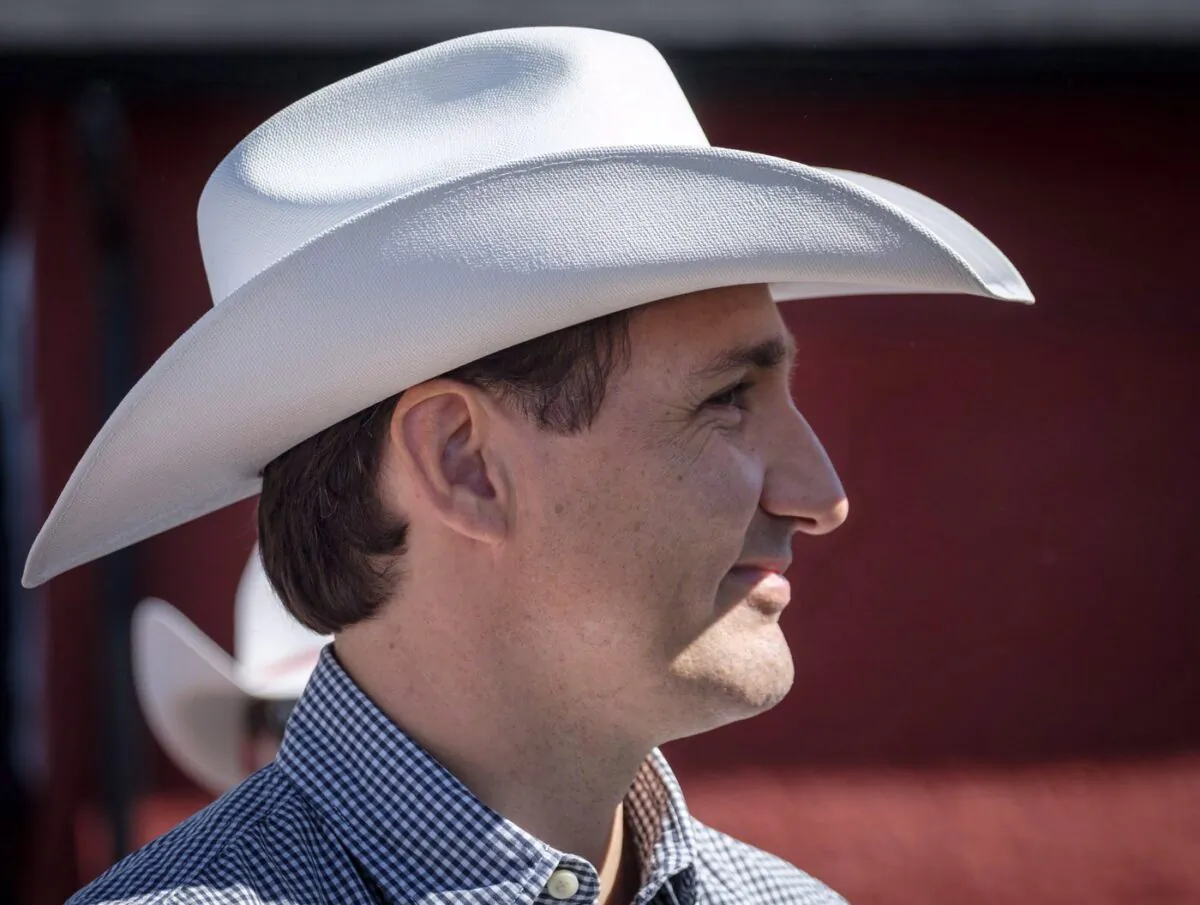 Prime Minister Justin Trudeau listens to speeches as he attends a pancake breakfast in Calgary on July 7, 2018. (The Canadian Press/Jeff McIntosh)