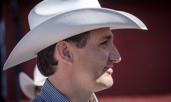 Prime Minister Justin Trudeau listens to speeches as he attends a pancake breakfast in Calgary on July 7, 2018. (The Canadian Press/Jeff McIntosh)