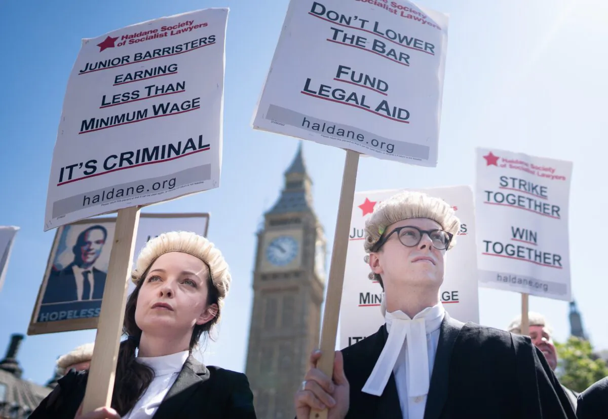 Criminal defence barristers rally in support of the ongoing Criminal Bar Association action, outside the Houses of Parliament, in London, on July 11, 2022. (Stefan Rousseau/PA Media)