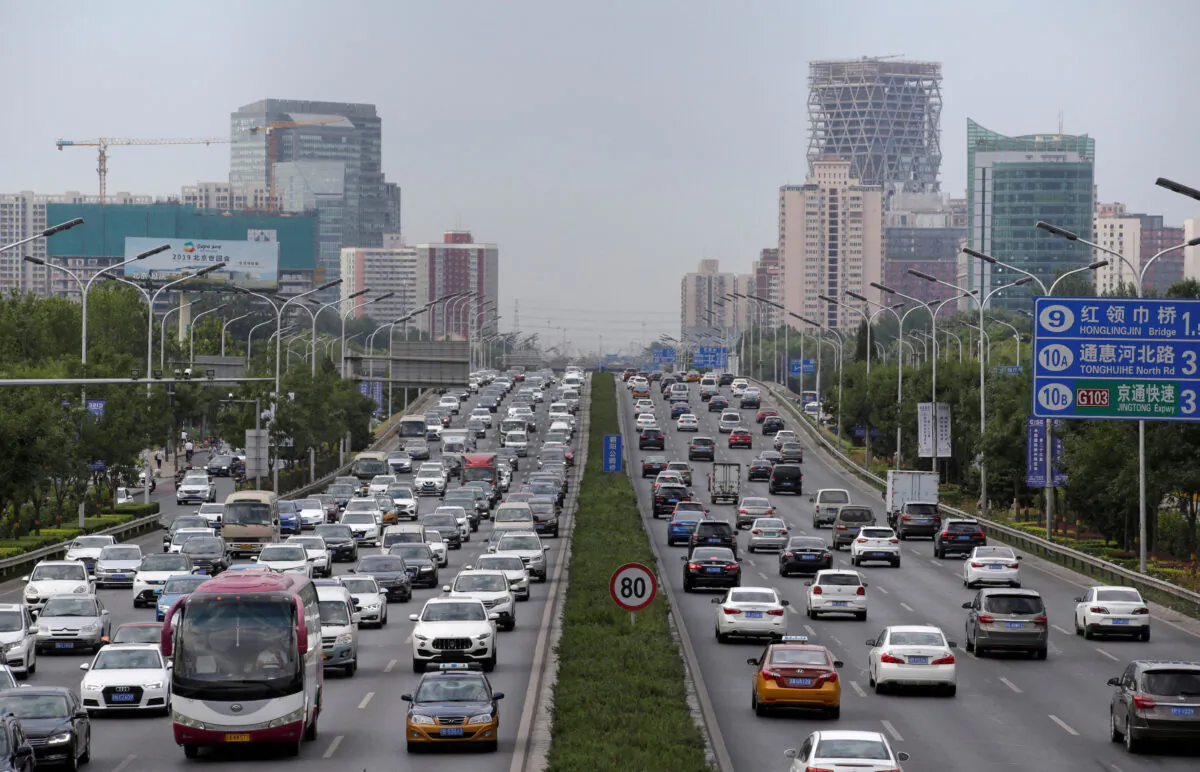 Cars drive on the road during the morning rush hour in Beijing on July 2, 2019. (Jason Lee/Reuters)