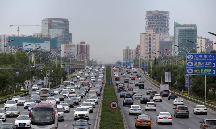 Cars drive on the road during the morning rush hour in Beijing on July 2, 2019. (Jason Lee/Reuters)