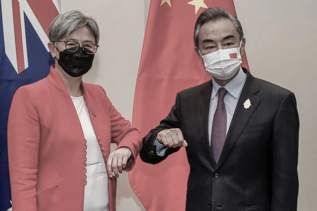 Australia's Foreign Minister Penny Wong (L) bumps elbows with China's Foreign Minister Wang Yi during their bilateral meeting on the sidelines of G20 Foreign Ministers Meeting in Nusa Dua on Indonesia's resort island of Bali on July 8, 2022. (Johannes P. Christo/POOL/AFP via Getty Images)