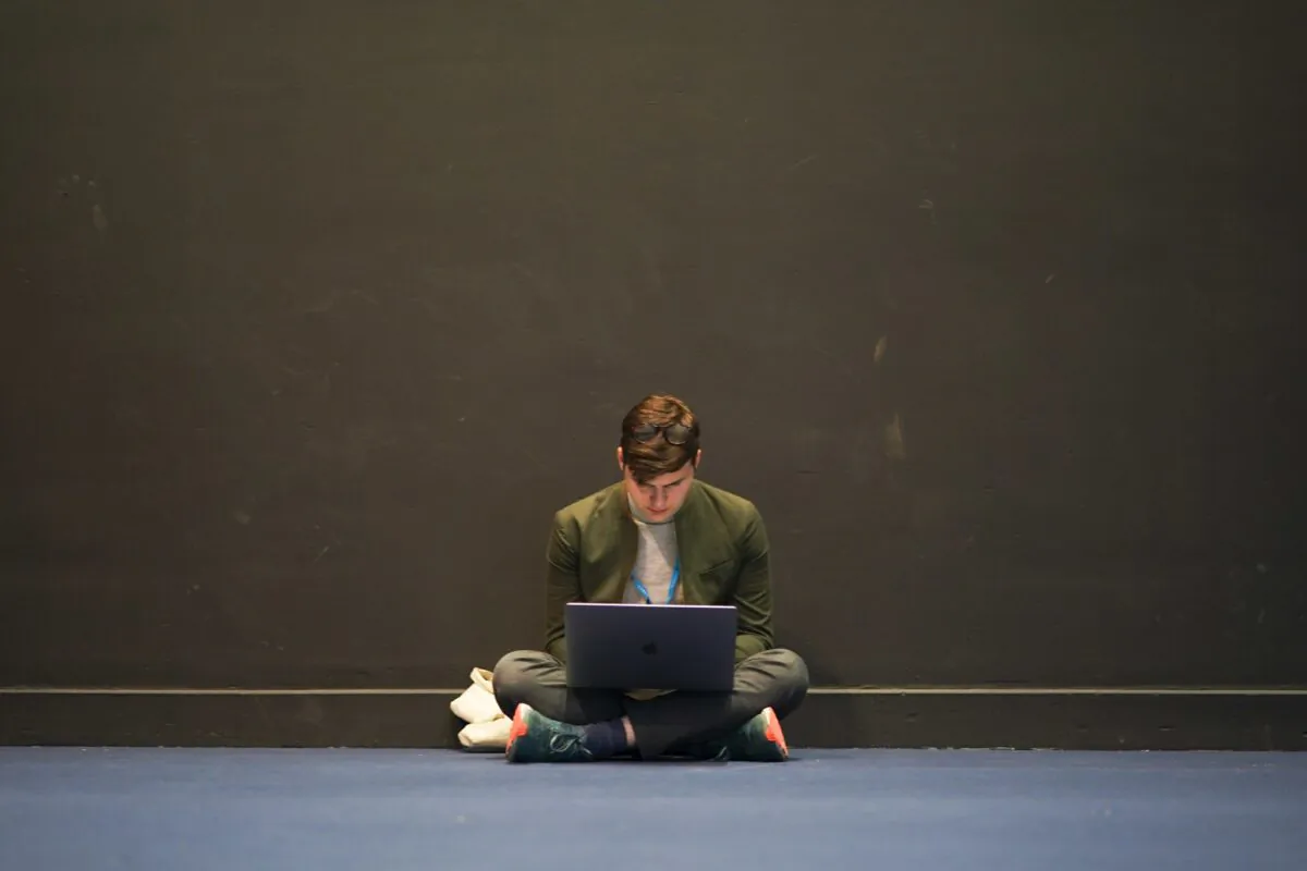 A delegate works on his laptop on the third day of the Conservative Party Conference at Manchester Central Convention Complex in Manchester, England, on Oct. 5, 2021. (Ian Forsyth/Getty Images)