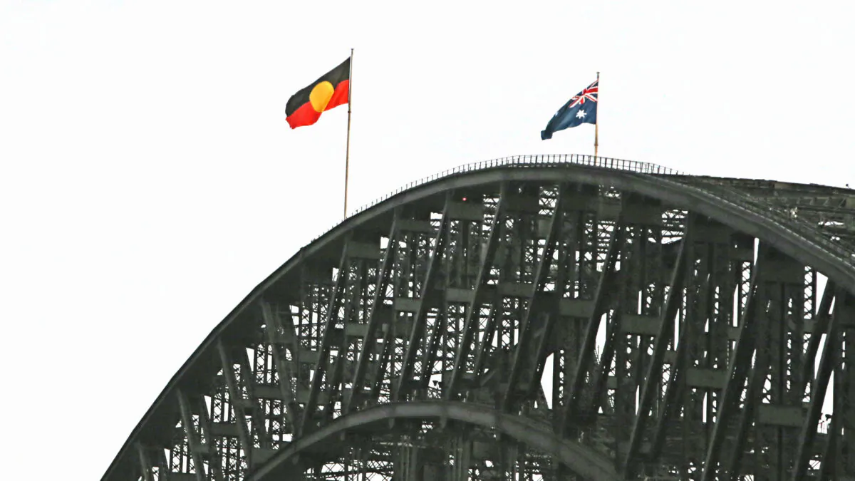 The Aboriginal flag is seen alongside the Australian flag on top of the Harbour Bridge in Sydney, Australia on Jan. 26, 2022. (Lisa Maree Williams/Getty Images)