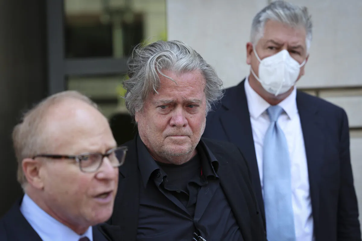 Steve Bannon (C), advisor to former President Donald Trump, listens as his attorney David Schoen (L) speaks to the media outside of the E. Barrett Prettyman U.S. Courthouse in Washington, on June 15, 2022. (Win McNamee/Getty Images)