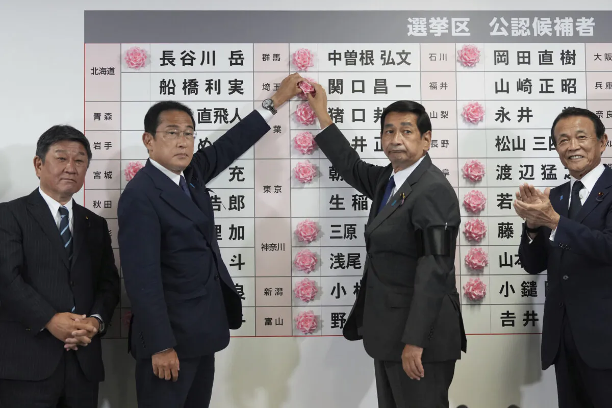 Japan's prime minister and president of the Liberal Democratic Party (LDP) Fumio Kishida, second left, speaks after placing a red paper rose on an LDP candidate's name, to indicate a victory in the upper house election, at the party's headquarters in Tokyo, Japan, on July 10, 2022. (Toru Hanai, Pool Photo via AP)