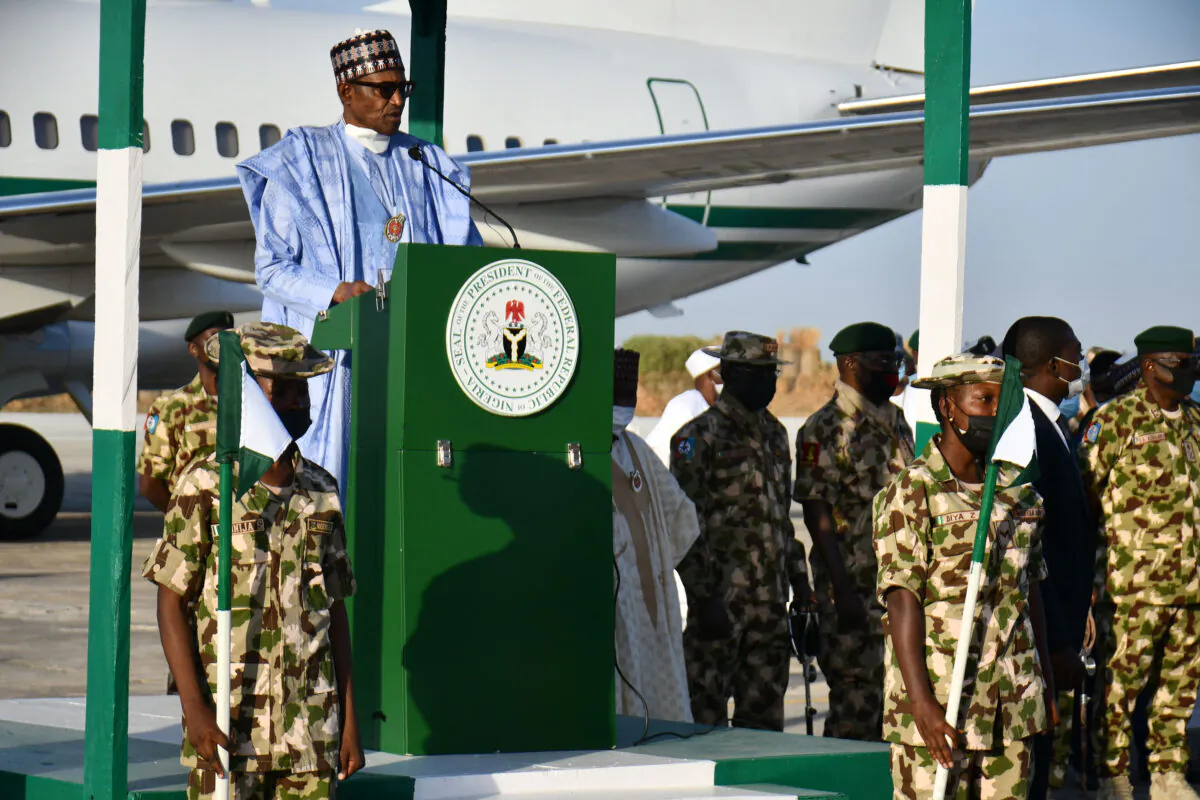 Nigerian president Muhammadu Buhari addresses troops at an airforce base at Maiduguri on Dec. 23, 2021, at which four people were killed by jihadist rockets hours before he arrived. 
(Audu Marte/AFP via Getty Images)