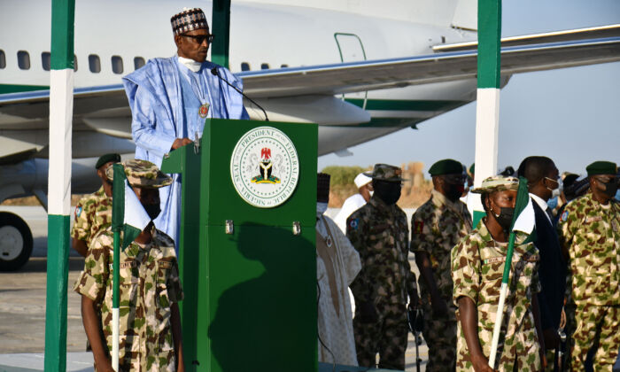 Nigerian president Muhammadu Buhari addresses troops at an airforce base at Maiduguri on Dec. 23, 2021, at which four people were killed by jihadist rockets hours before he arrived. 
(Audu Marte/AFP via Getty Images)