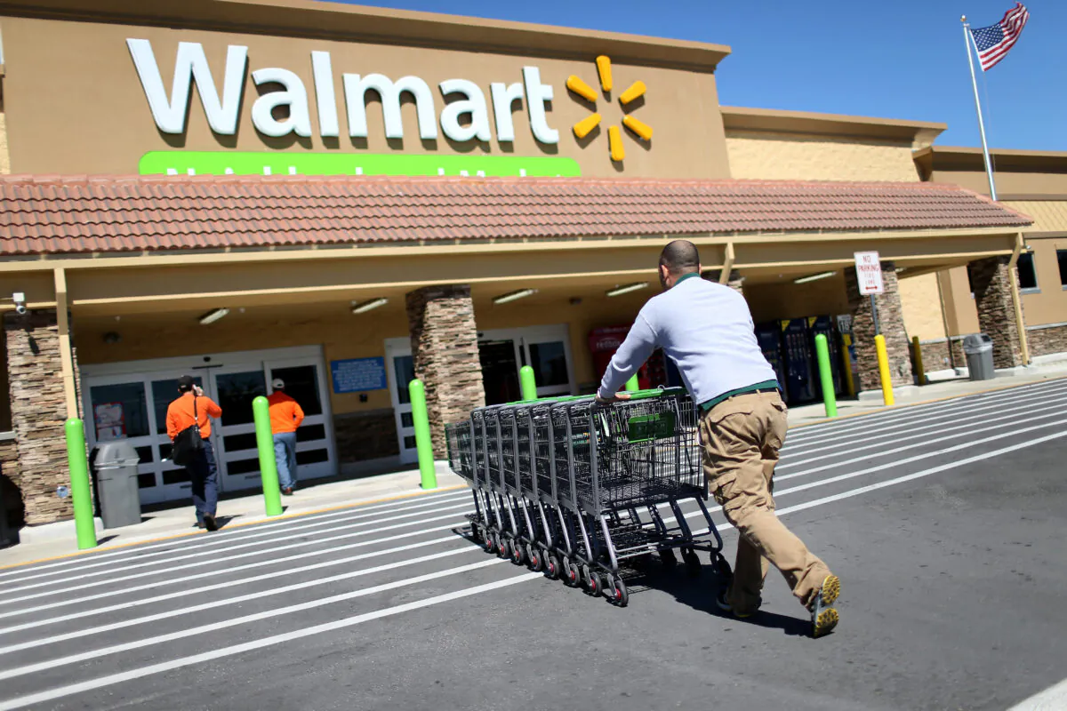 A Walmart employee pushes grocery carts at a store in Miami, Fla., on Feb. 19, 2015. (Joe Raedle/Getty Images)