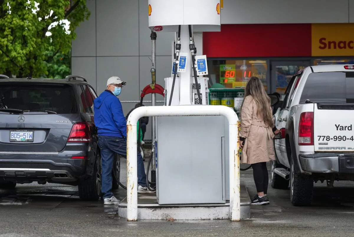 A Canadian small business group is calling on the federal and provincial governments to temporarily eliminate or lower fuel taxes. People fuel up vehicles at a Shell gas station in Vancouver on May 14, 2022. (The Canadian Press/Darryl Dyck)