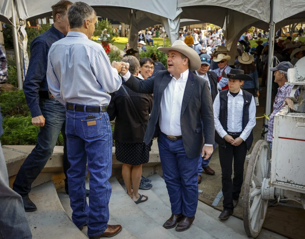 Alberta Premier Jason Kenney, centre, attends his last Premier's annual Stampede breakfast as premier in Calgary, Alta., July 11, 2022. (The Canadian Press/Jeff McIntosh)