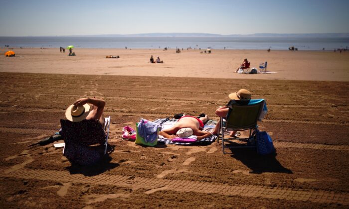 People on the beach at Barry Island, Wales, on July 11, 2022. (Ben Birchall/PA Media)
