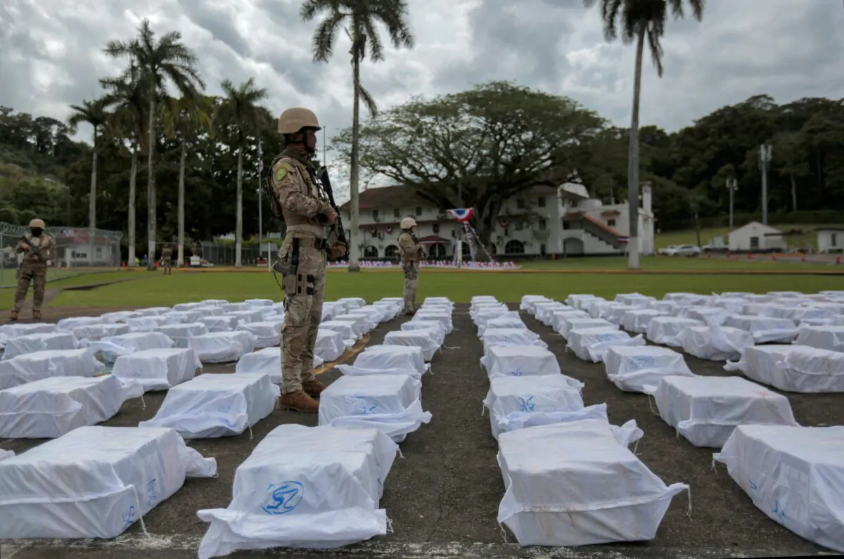Members of the National Aeronaval Service (SENAN) guard drug packages as they are displayed during a press conference at a base in Panama City on Oct. 30, 2021. (Rogelio Figueroa/AFP via Getty Images)