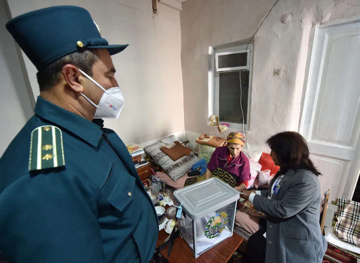An elderly woman casts her ballot as she votes at home during Uzbekistan's presidential election in Tashkent on October 24, 2021. (Vyacheslav Oseledko/ AFP via Getty Images)