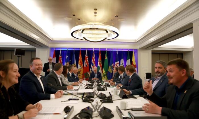 Premiers mingle during a photo op while at the summer meeting of the Canada's Premiers at the Fairmont Empress in Victoria, on July 11, 2022. (The Canadian Press/Chad Hipolito)