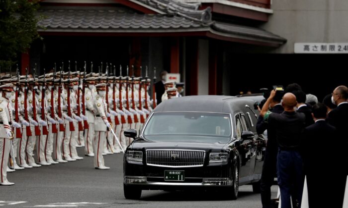 A vehicle carrying the body of the late former Japanese Prime Minister Shinzo Abe leaves after his funeral at Zojoji Temple in Tokyo, Japan, on July 12, 2022. (Issei Kato/Reuters)
