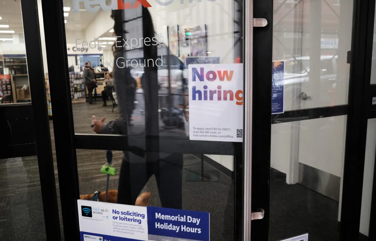 A "now hiring" sign hangs in a store window in the Manhattan borough of New York City on May 6, 2022. (Spencer Platt/Getty Images)
