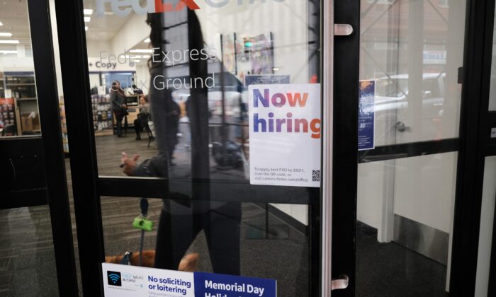 A "now hiring" sign hangs in a store window in the Manhattan borough of New York City on May 6, 2022. (Spencer Platt/Getty Images)