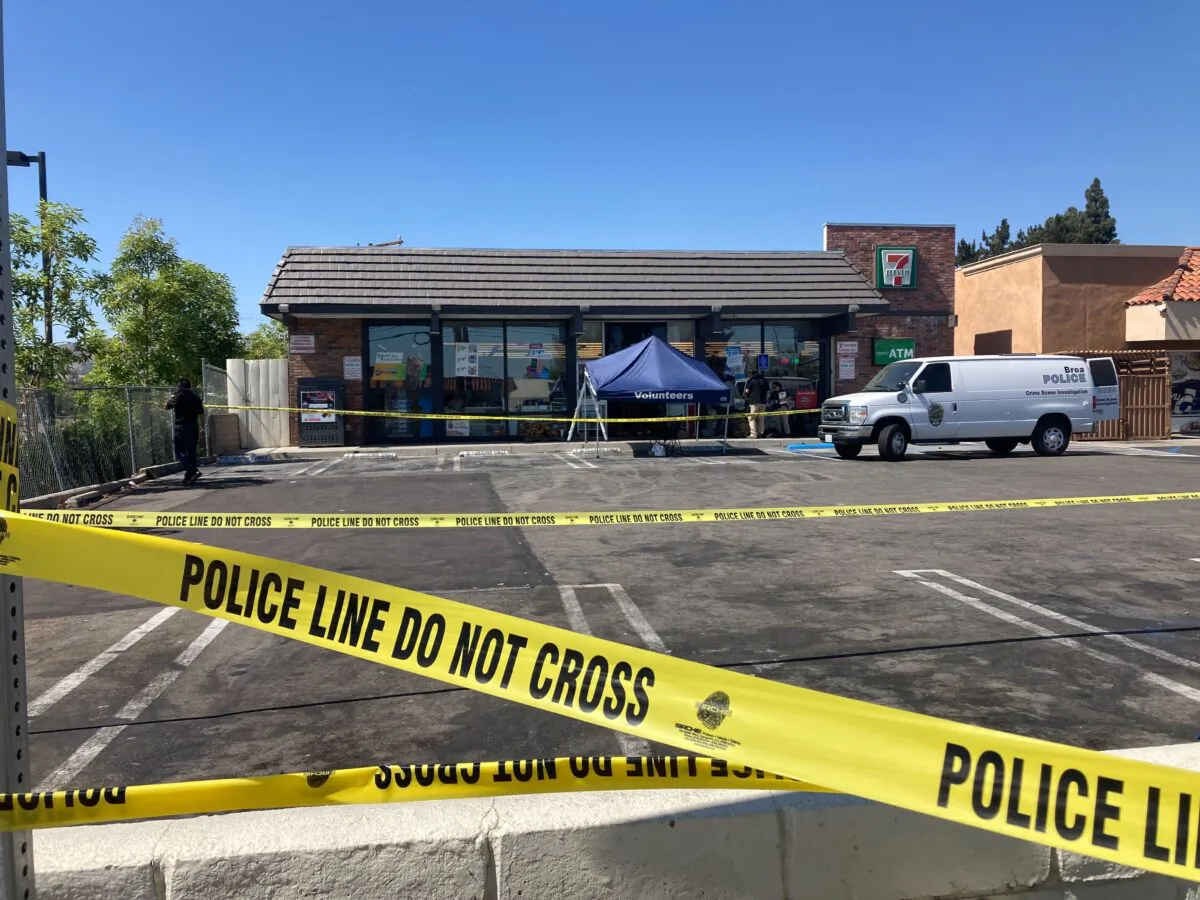 Police crime scene tape closes off a parking area following a shooting at a 7 Eleven store in Brea, Calif., on July 11, 2022. (Eugene Garcia/AP Photo)