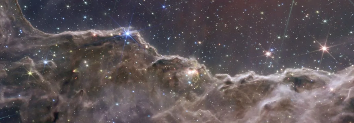 This image released by NASA on July 12, 2022, combined the capabilities of the James Webb Space Telescope's two cameras to create a never-before-seen view of a star-forming region in the Carina Nebula. (NASA, ESA, CSA, STScI via AP)