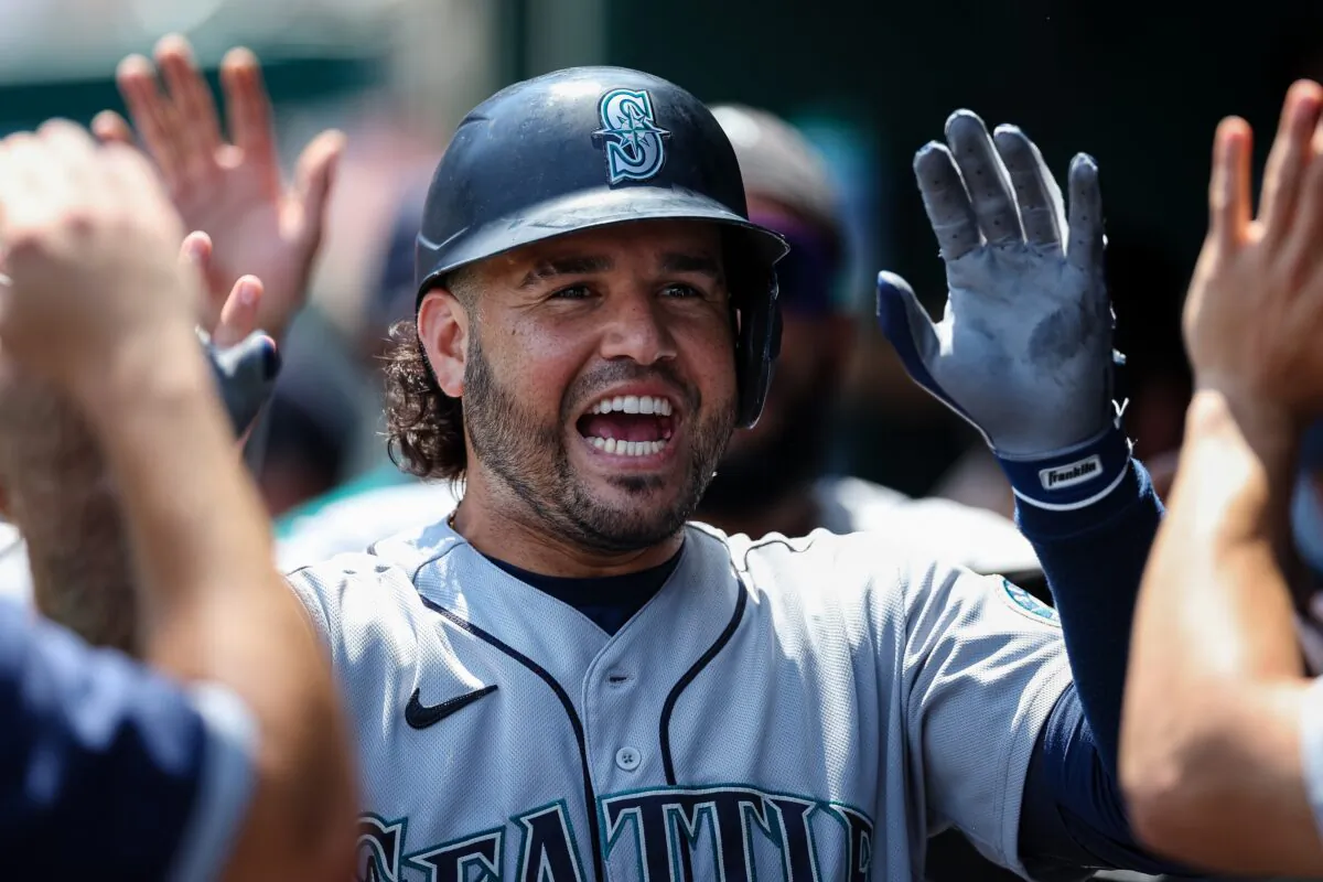Eugenio Suarez (28) of the Seattle Mariners celebrates with teammates after hitting a three run home run against the Washington Nationals during the first inning of game one of a doubleheader at Nationals Park in Washington on July 13, 2022. (Scott Taetsch/Getty Images)