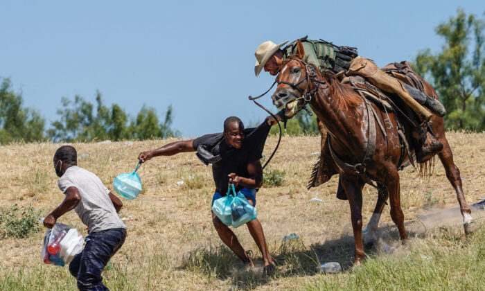 A U.S. Border Patrol agent on horseback tries to stop a Haitian migrant from entering an encampment on the banks of the Rio Grande near the Acuna Del Rio International Bridge in Del Rio, Texas, on Sept. 19, 2021. (Paul Ratje/AFP/Getty Images)