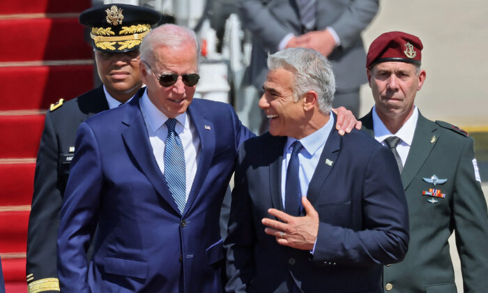 President Joe Biden (L) is welcomed by Israeli caretaker Prime Minister Yair Lapid after arriving at Israel's Ben Gurion Airport in Lod near Tel Aviv, on July 13, 2022. (Jack Guez/AFP via Getty Images)