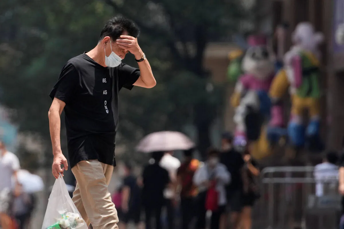 A man reacts on a street amid a heatwave warning in Shanghai, on July 13, 2022.(Aly Song/Reuters)