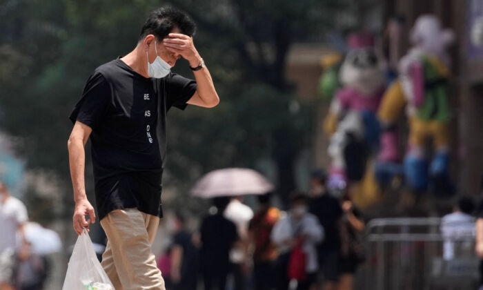 A man reacts on a street amid a heatwave warning in Shanghai, on July 13, 2022.(Aly Song/Reuters)