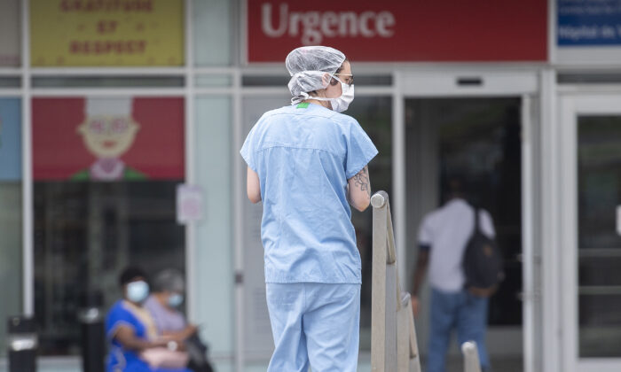 A health care worker is outside a hospital in Montreal on July 14, 2022. (Graham Hughes/The Canadian Press)