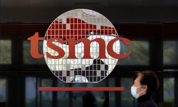 A man walks past a company logo at the headquarters of the world's largest semiconductor maker TSMC in Hsinchu, Taiwan, on Jan. 29, 2021. TSMC has started building a semiconductor factory in Arizona. (SAM YEH/AFP via Getty Images)