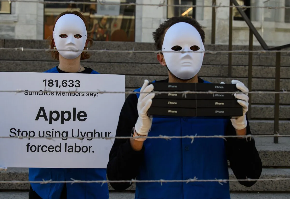 Activists set up a mock Uyghur forced labor camp outside the Apple flagship store in Washington, D.C., on March 4, 2022, to call on Apple to stop using Uyghur forced labor. (Nicholas Kamm/AFP/Getty Images)