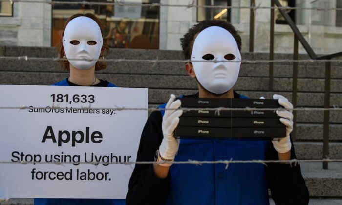 Activists set up a mock Uyghur forced labor camp outside the Apple flagship store in Washington, D.C., on March 4, 2022, to call on Apple to stop using Uyghur forced labor. (Nicholas Kamm/AFP/Getty Images)