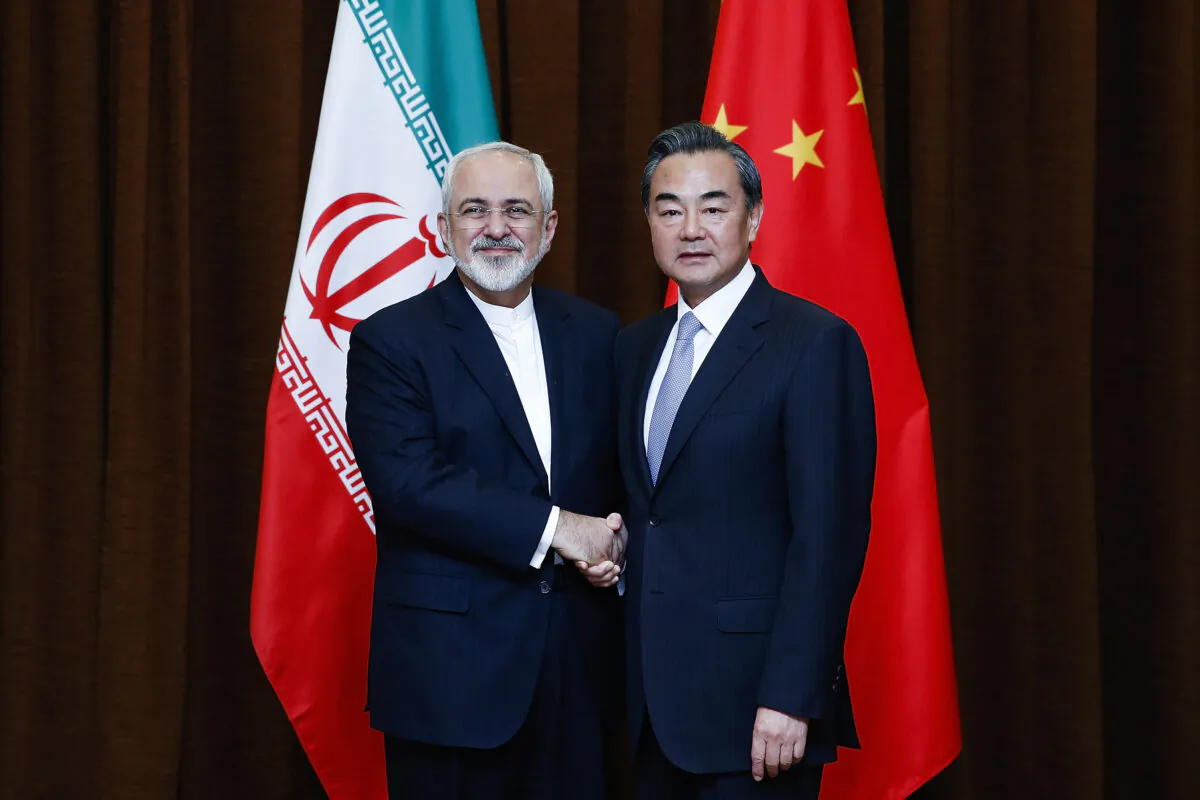 China's Foreign Minister Wang Yi (R) shakes hands with Iranian Foreign Minister Javad Zarif before a bilateral meeting in Beijing, China, on Sept. 15, 2015. (Lintao Zhang/Pool/Getty Images)