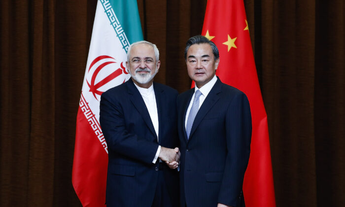 China's Foreign Minister Wang Yi (R) shakes hands with Iranian Foreign Minister Javad Zarif before a bilateral meeting in Beijing, China, on Sept. 15, 2015. (Lintao Zhang/Pool/Getty Images)
