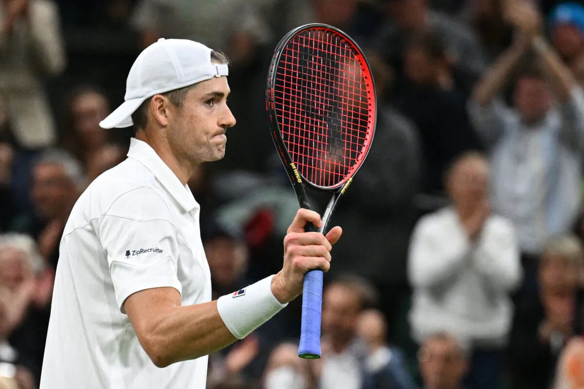 U.S. player John Isner celebrates beating Britain's Andy Murray during their men's singles tennis match on the third day of the 2022 Wimbledon Championships at The All England Tennis Club in Wimbledon, southwest London, on June 29, 2022. (Sebastien Bozon/AFP via Getty Images)