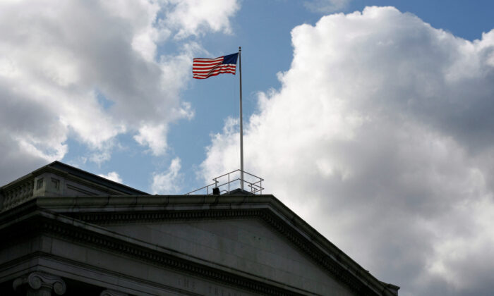 The U.S. flag flies atop the Treasury Department in Washington on Nov. 18, 2008. (Jim Bourg/Reuters)