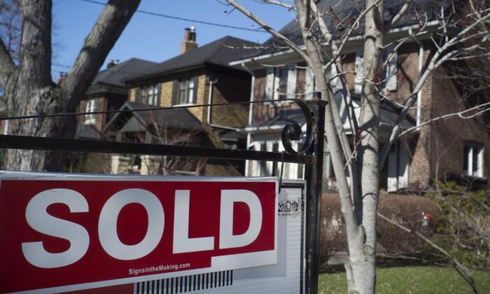 A sold sign is shown in front of west-end Toronto homes April 9, 2017. (The Canadian Press/Graeme Roy)