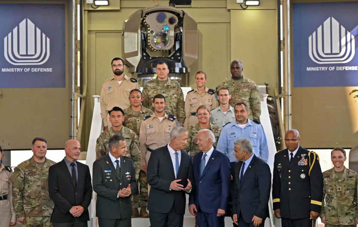 U.S. President Joe Biden (4th R) listens to Israeli Defense Minister Benny Gantz (4th L), as they tour the Israel's missile defense system at Ben Gurion Airport near Tel Aviv, Israel, on July 13, 2022. (Mandel Ngan/AFP via Getty Images)