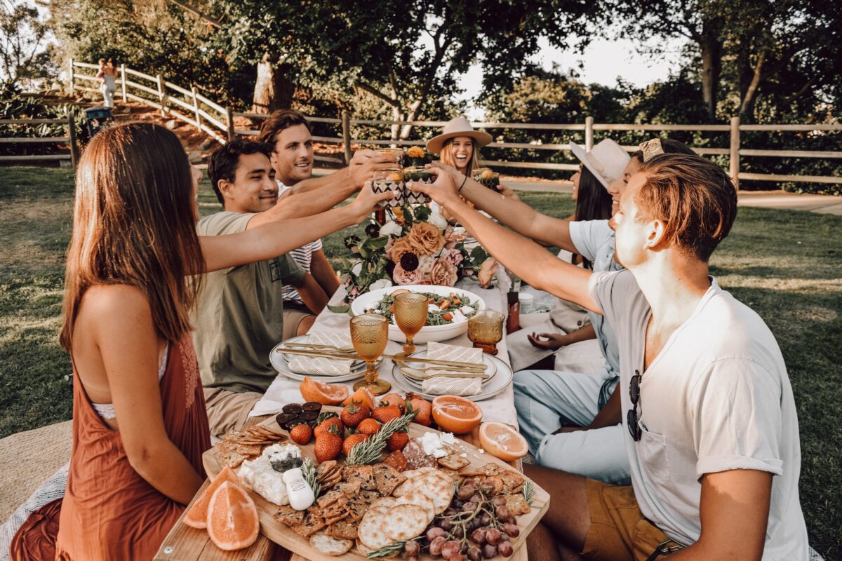 A picnic is the perfect way to reconnect with friends and family, as you gather around a delicious spread of food in the open air and sunshine. (Nicole Herrero/Unsplash)