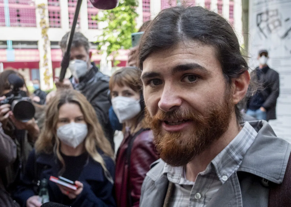 Franco A. walks to a court for the start of a trial on charges of preparing a serious act of violence endangering the state, in Frankfurt, Germany, on May 20, 2021. (Michael Probst/AP Photo)