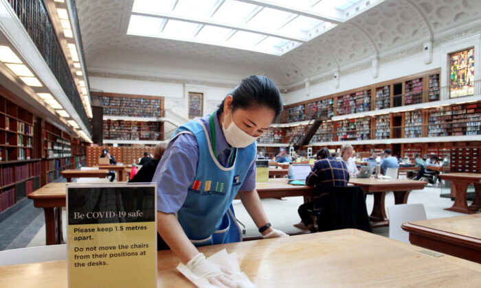 A member of the cleaning staff wipes down a table in the State Library of New South Wales in Sydney, Australia, on June 1, 2020. (Lisa Maree Williams/Getty Images)